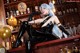 A woman in a black latex outfit sitting at a bar.