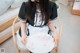 A woman sitting on a chair holding a plate.