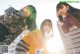 A group of three young women standing next to each other.