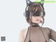 A woman wearing a pair of cat ears and headphones.